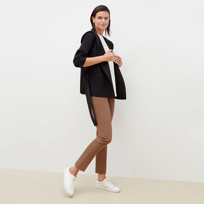 Side image of a woman standing wearing the Foster Pant—Everstretch in Saddle