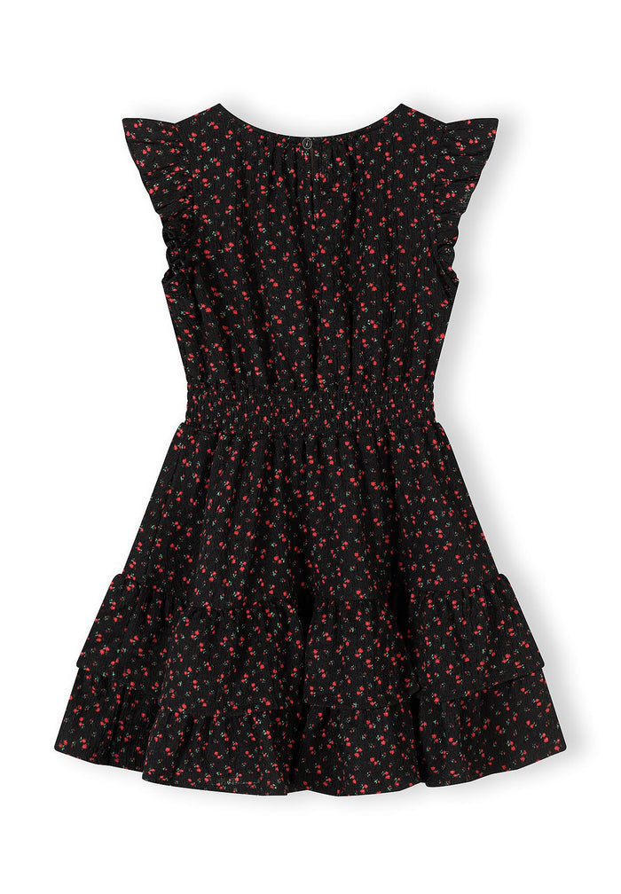 Girls black floral A-line dress with frill sleeves, back view.