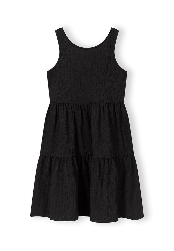 Girls tiered sleeveless black summer dress, front view, featuring a flared skirt.