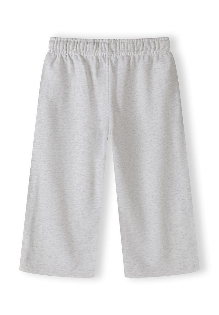Detail of girls' grey marl jogging trousers with elastic waistband.