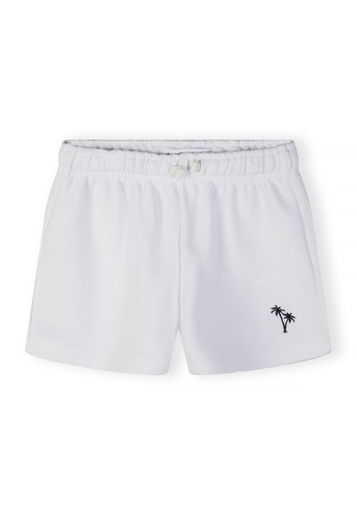 Girls white shorts with elastic waistband and palm tree embroidery, front view.