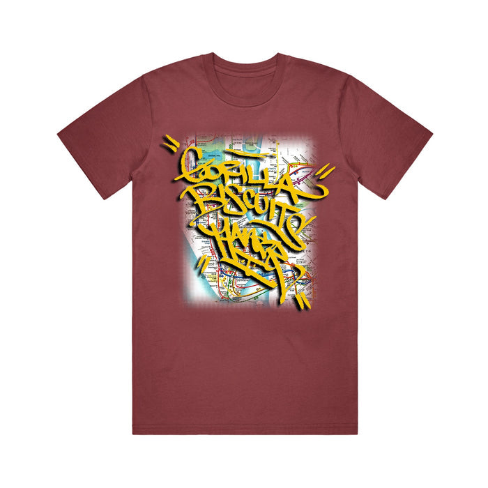 A maroon Gorilla Biscuits t-shirt with bold yellow Gorilla Biscuits NYC graffiti text over a faded subway map background.