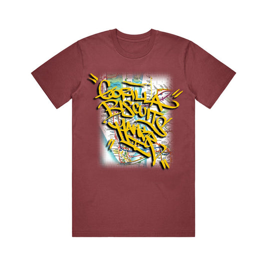 A maroon Gorilla Biscuits t-shirt with bold yellow Gorilla Biscuits NYC graffiti text over a faded subway map background.