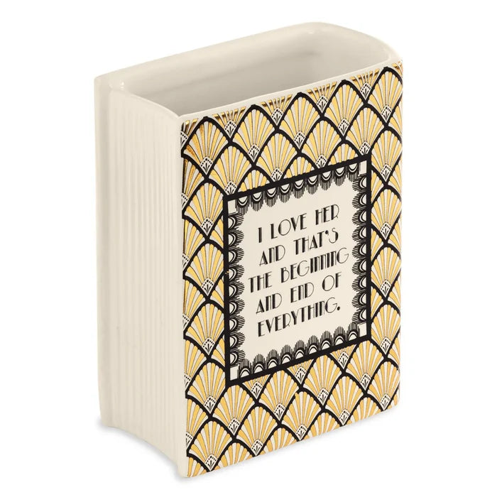 A rectangular vase shaped as a book featuring the Great Gatsby cover. The back shows text that reads: I love her and that's the beginning and the end of everything.