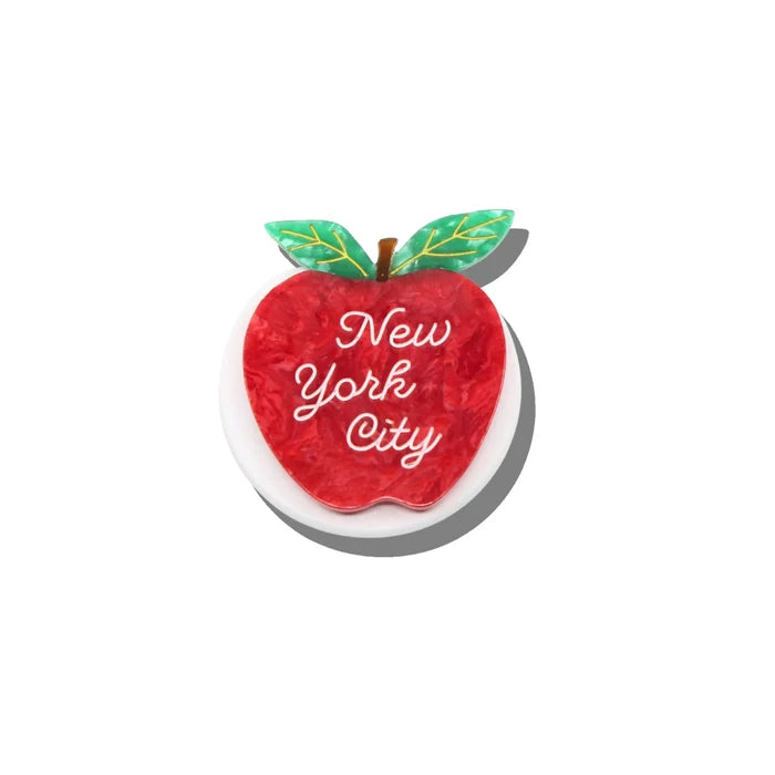 Red apple-shaped phone holder with 'New York City' text on a white background
