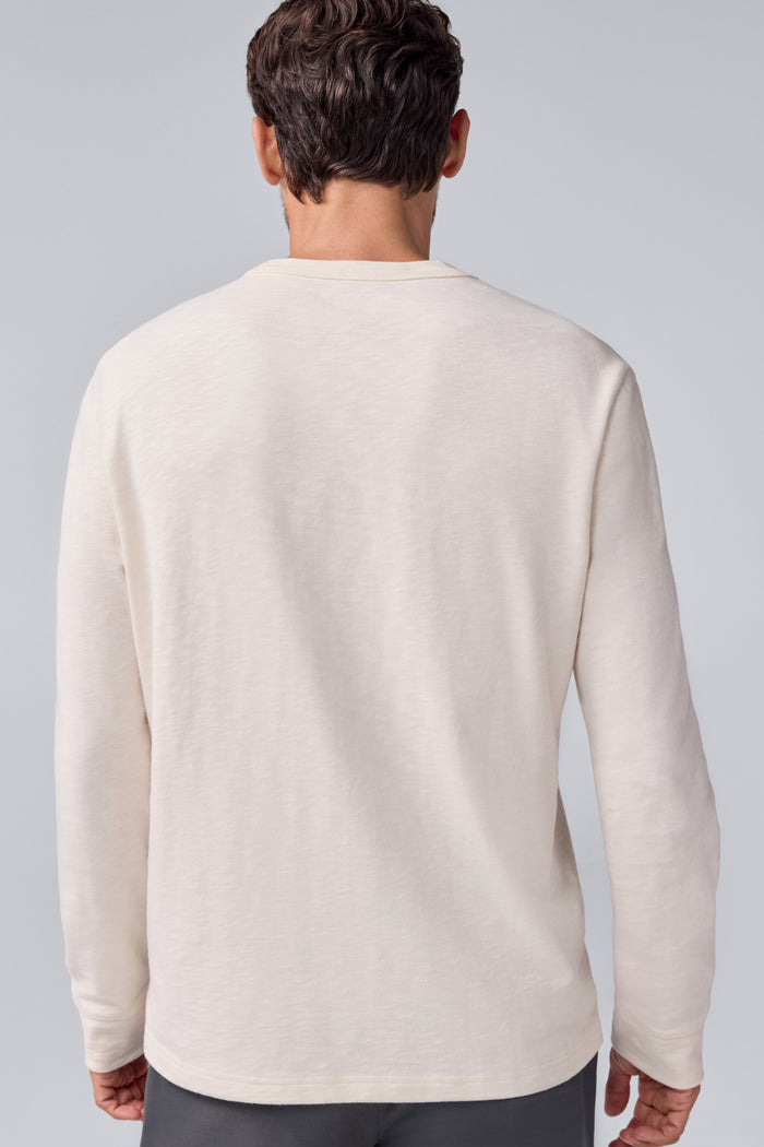 Back view of a man wearing Heavyweight Relaxed Long Sleeve T-Shirt in Froth