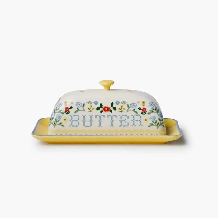 Butter dish with floral design and 'butter' text on a white background