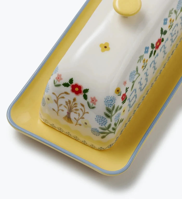 Decorative butter dish with floral patterns on a white background