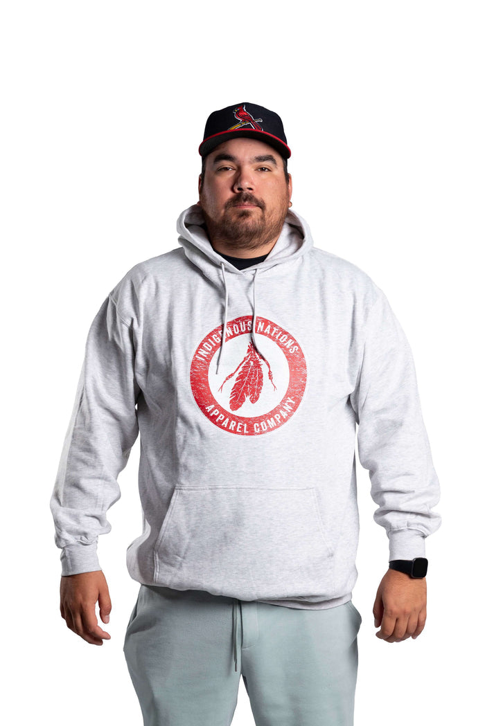 Person wearing a gray INAC Distressed Feather hoodie with red logo front view