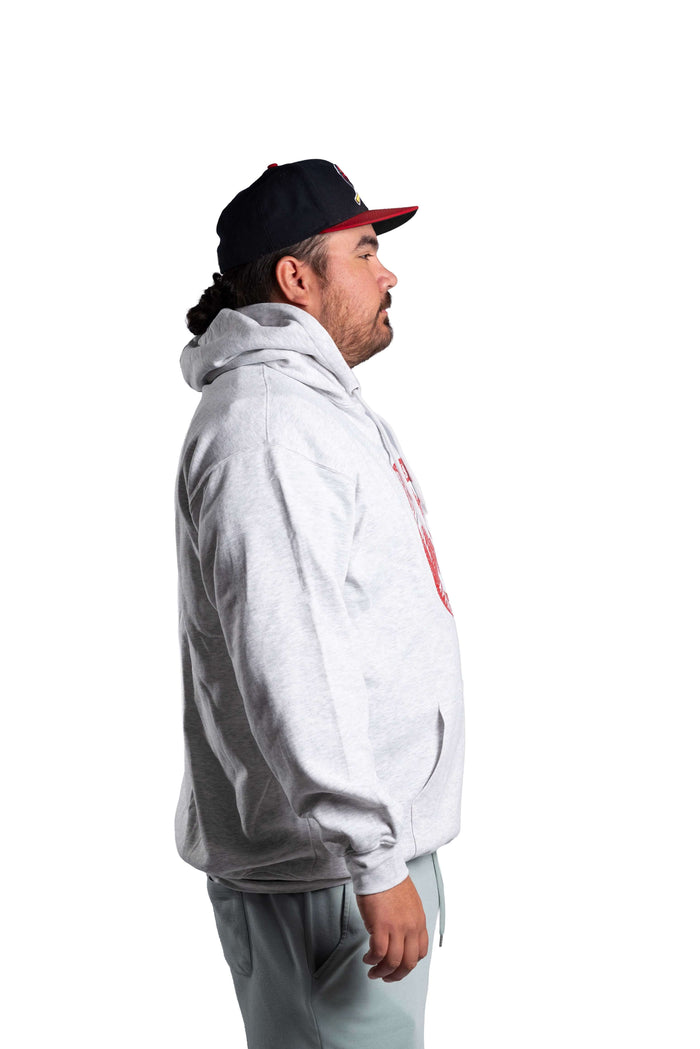 Person wearing a white INAC Distressed Feather hoodie with cap side view