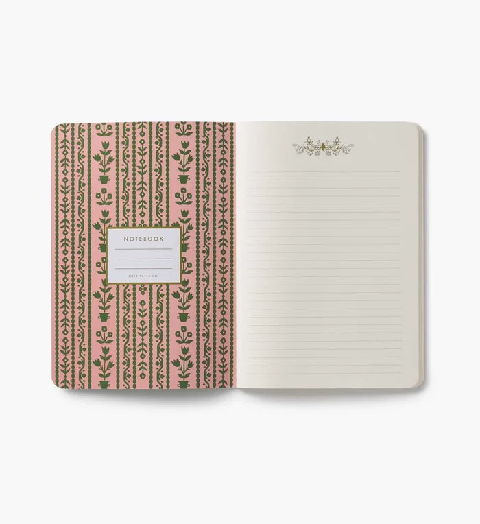 Open notebook with floral patterned cover on a white background