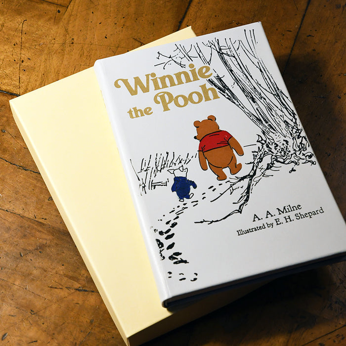 Off-white book titled 'Winnie the Pooh' on a wooden surface