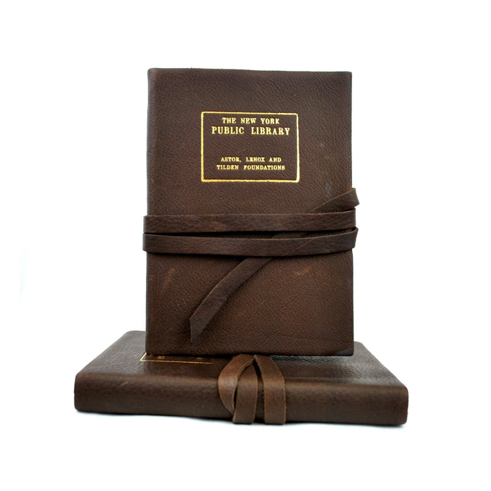 Leather journal with The New York Public Library gold stamp, tied with string.