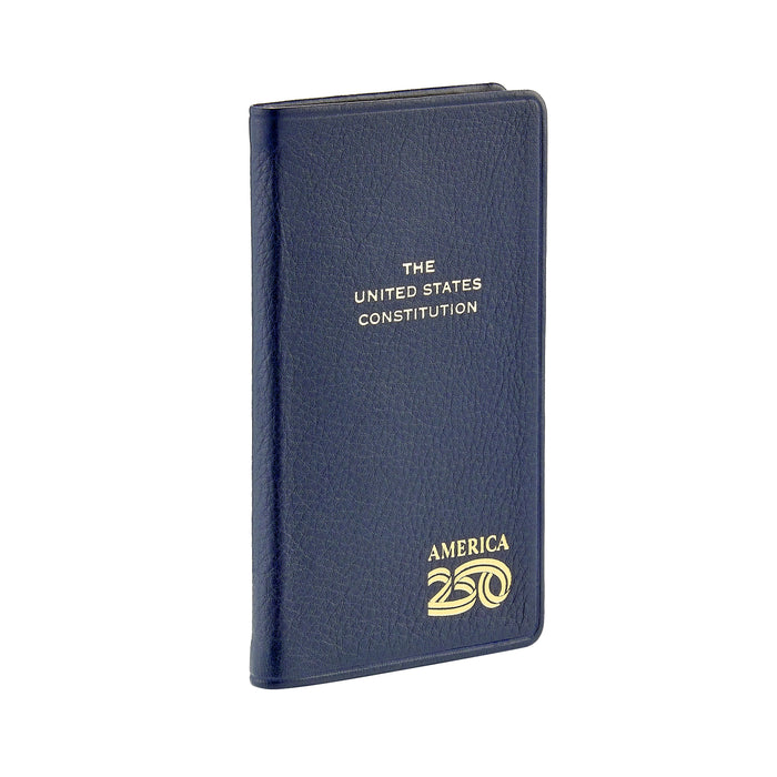 A pocket-sized, navy blue leather-bound edition of "The United States Constitution" featuring gold embossed text and a commemorative "America 250" logo