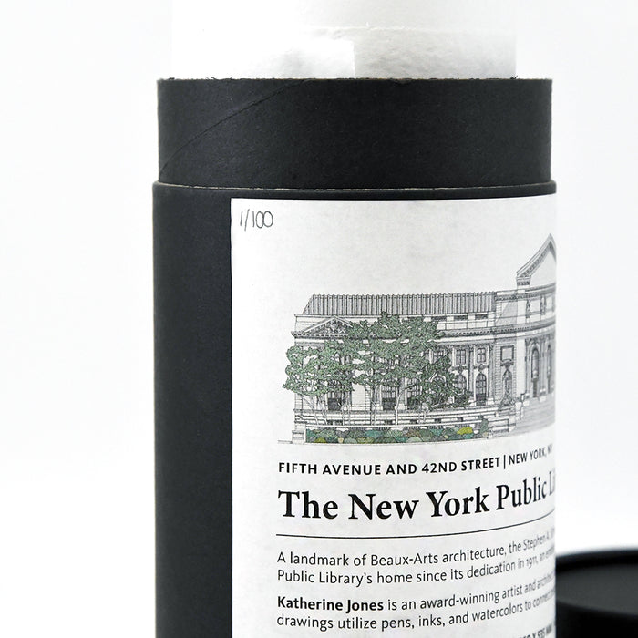 Candle in a cylindrical container with a label featuring 'The New York Public Library' on a white background.