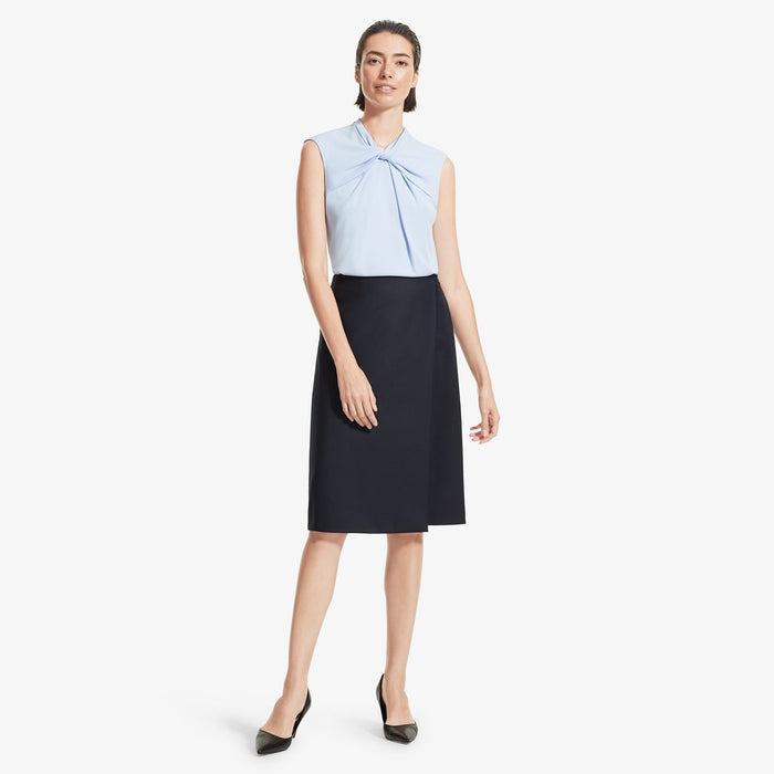 Front image of a woman standing wearing the Logan skirt sharkskin in Ink | Lead
