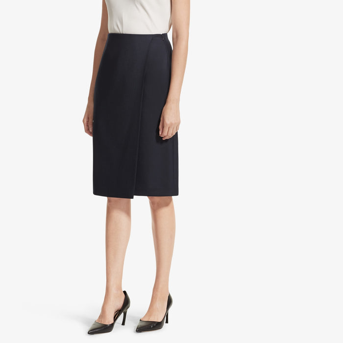 Front image of a woman standing wearing the Logan skirt sharkskin in Ink