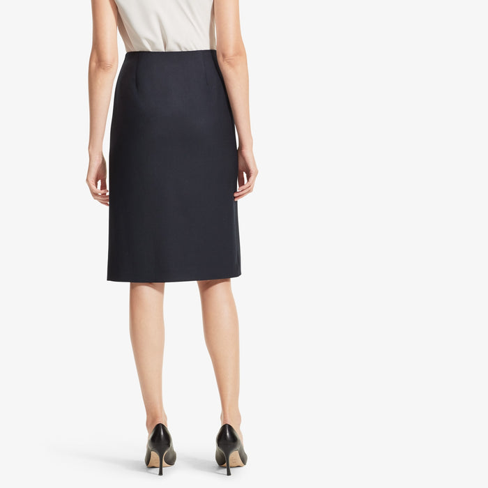 Back image of a woman standing wearing the Logan skirt sharkskin in Ink
