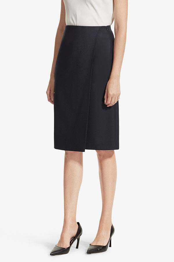 Front image of a woman standing wearing the Logan skirt sharkskin in Ink | Grid | Exclude