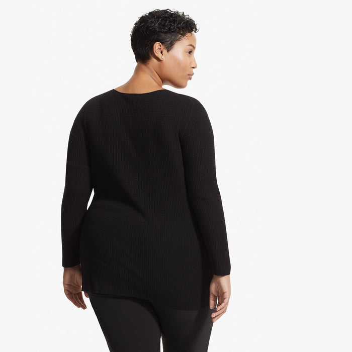 Back image of a woman standing wearing the Loraine top in Black