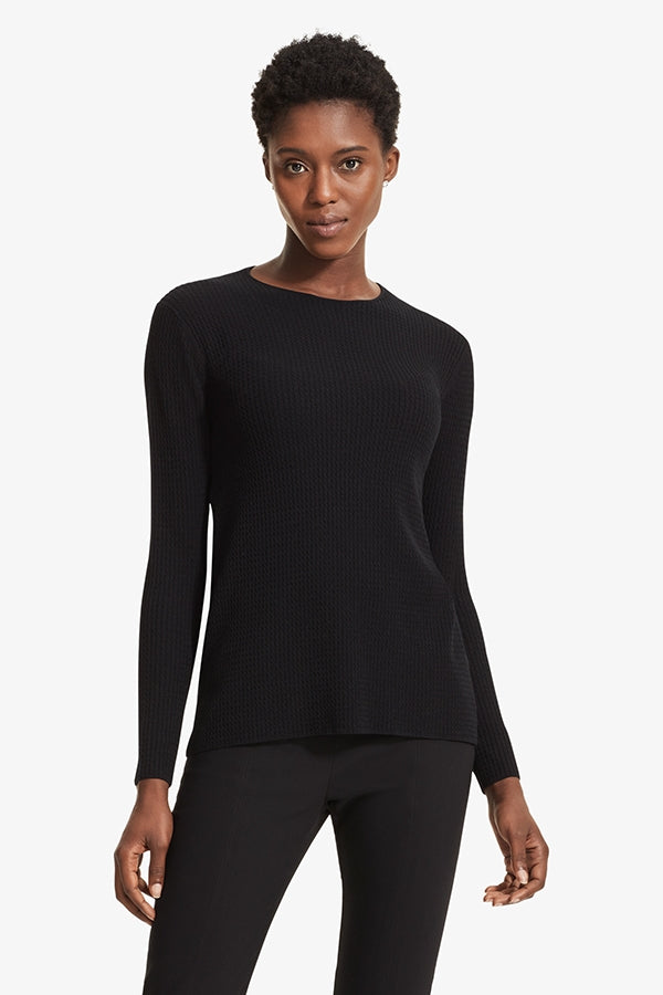 Front image of a woman standing wearing the Loraine top in Black | Grid | Exclude