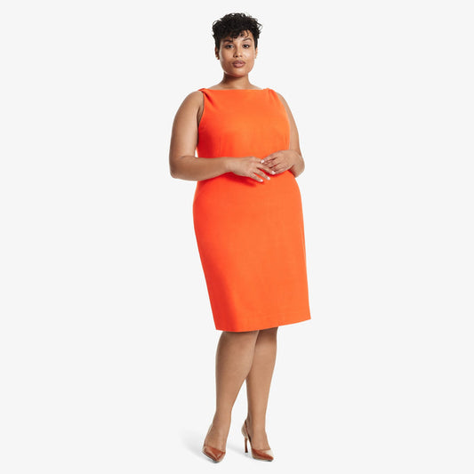 Front image of a woman standing wearing the Lydia dress textured ponte in Tangerine | Lead