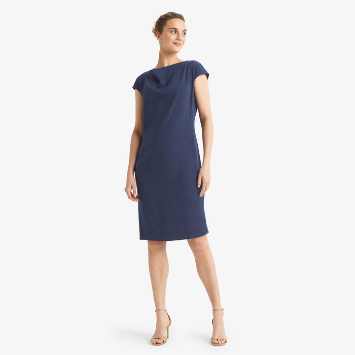 Front image of a woman standing wearing the Marilyn dress stretch linen in blueberry | Lead