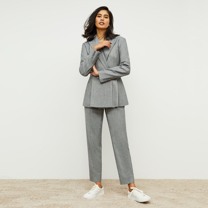 Front image of a woman standing wearing the Mejia pant sharkskin in Black and white
