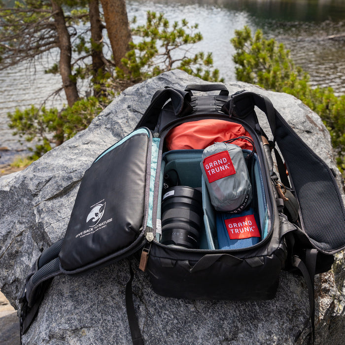 Nano 7 Hammock in camera bag on a rock in the woods