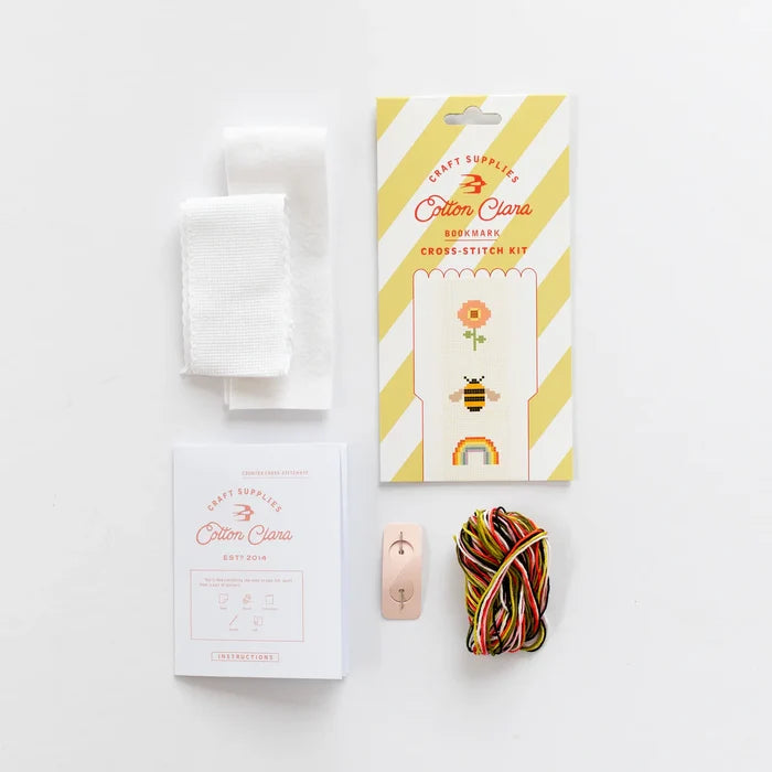 Cotton Clara cross-stitch kit with packaging, thread, and needle on a white background
