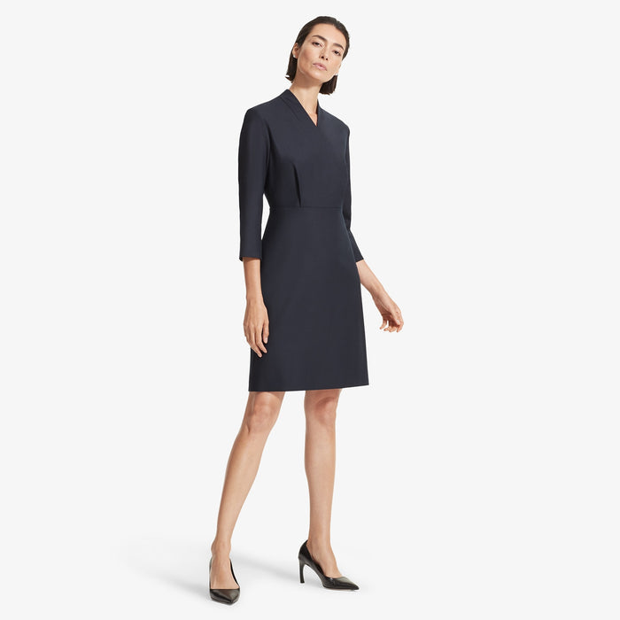 Front image of a woman standing wearing the Niko dress sharkskin in Ink | Lead