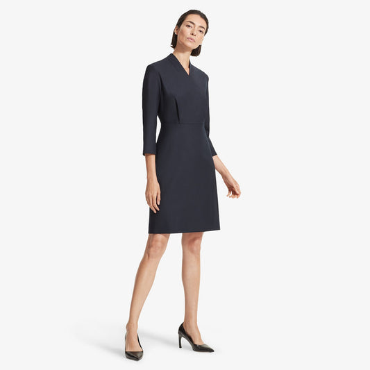Front image of a woman standing wearing the Niko dress sharkskin in Ink | Lead