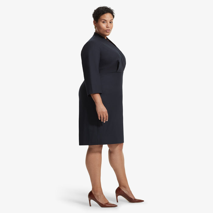 Side image of a woman standing wearing the Niko dress sharkskin in Ink