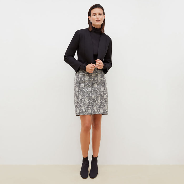 Front image of a woman standing wearing the Noho skirt in crackle