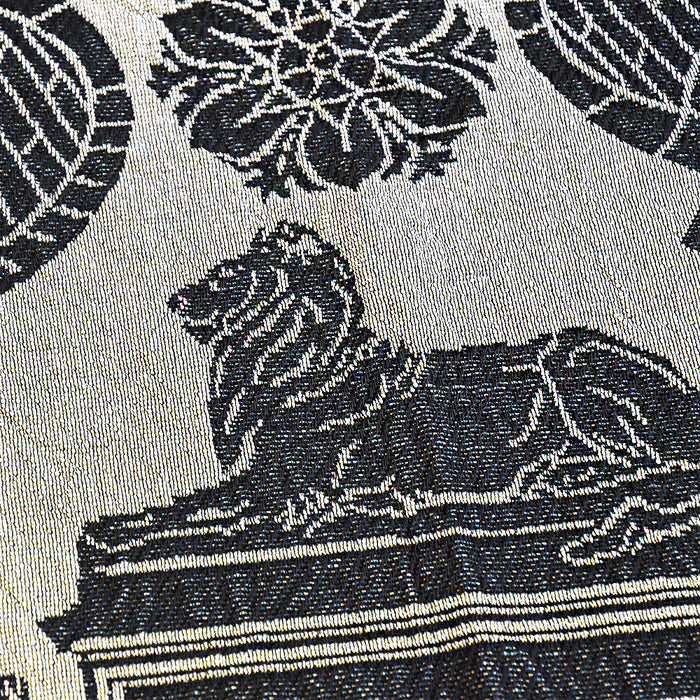 Textile pattern with a black lion design on a light beige background
