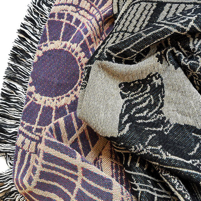 Close-up of patterned fabric with fringes on a white background