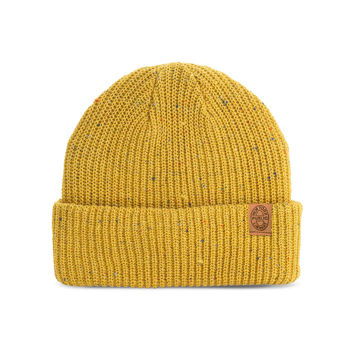 Yellow beanie with a brown leather patch with a NYPL oval stamp.