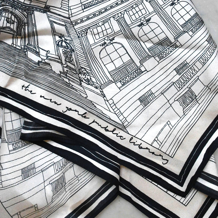 Close-up of the off-white silk scarf featuring a detailed black line-art illustration of NYPL's flagship building.