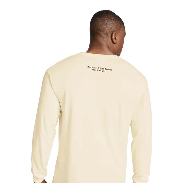 Man wearing a beige long-sleeve shirt with text on the back that reads: 42nd Street & Fifth Avenue. New York City.