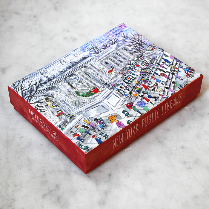 Box with a colorful illustration of the New York Public Library during the holidays scene on a marble surface