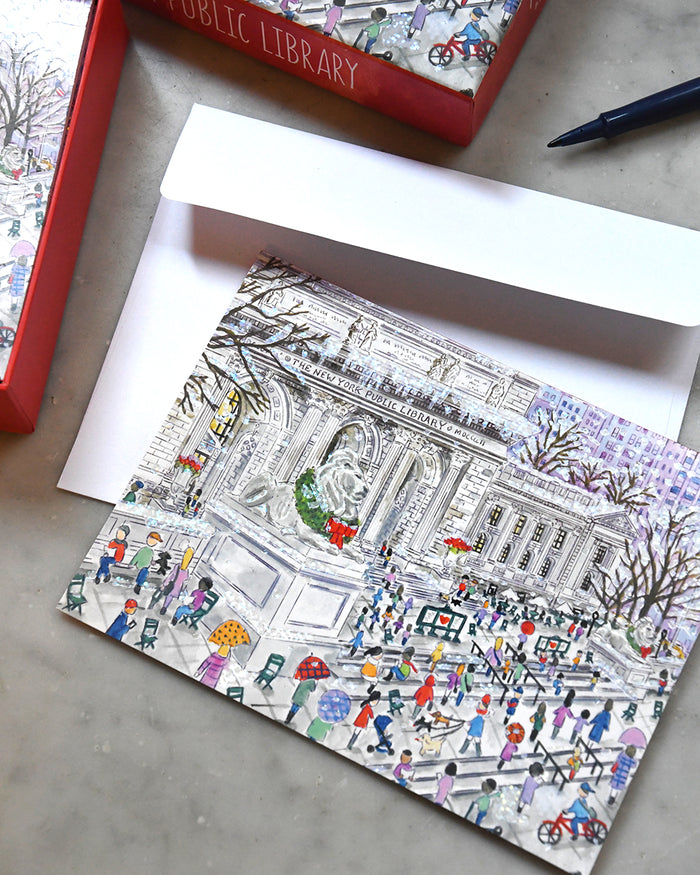 Illustrated greeting card with a public library scene and envelope on a concrete surface.
