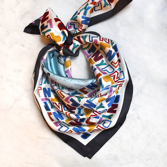 Colorful patterned scarf with geometric design on a light background