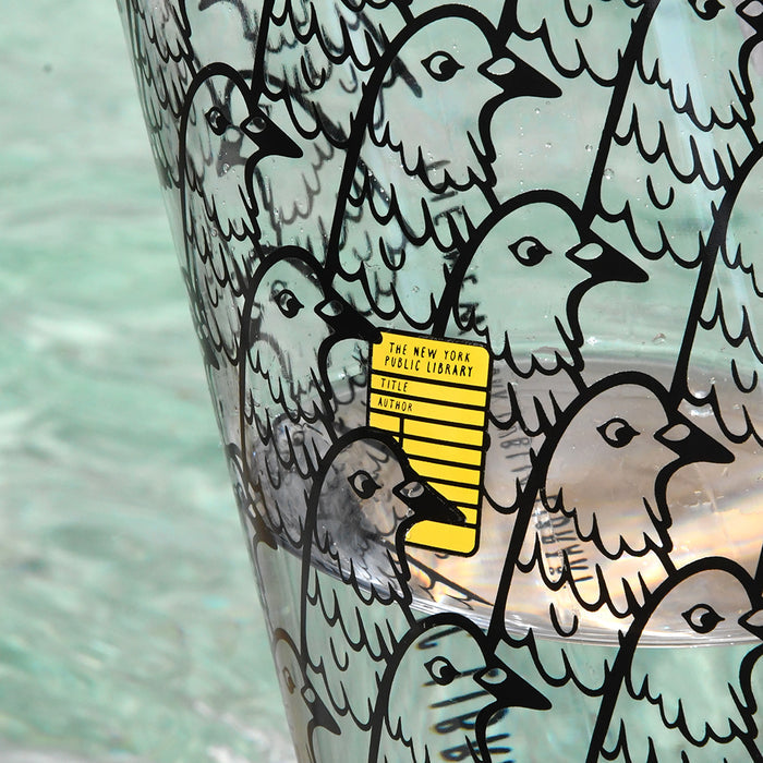 Close-up of the pigeon design and a yellow NYPL library card in the middle of it.