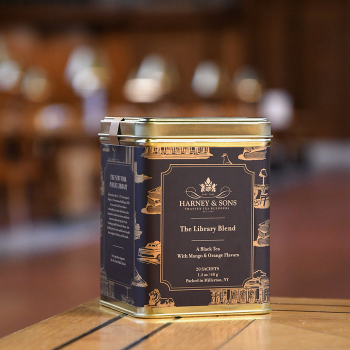 Harney & Sons The Library Blend tea canister on a wooden surface with a blurred background