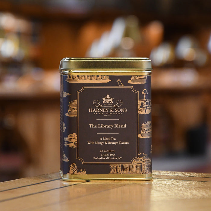 Harney & Sons tea canister on a wooden surface with a blurred background
