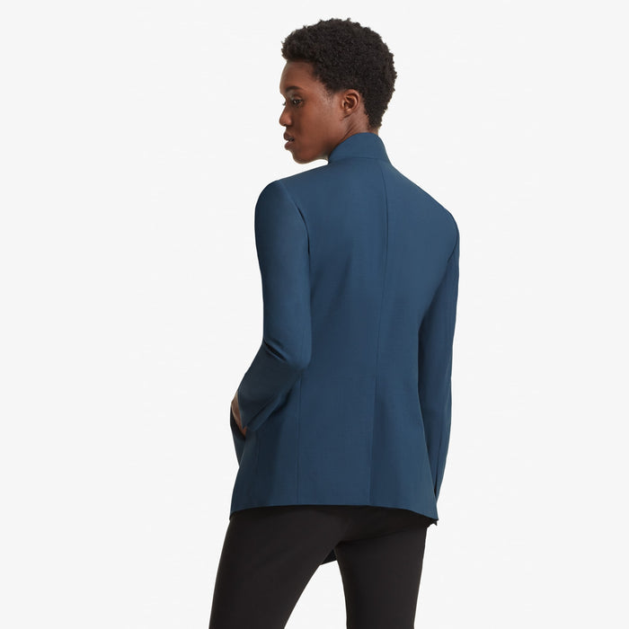 Back image of a woman standing wearing the Oliver jacket in Twilight