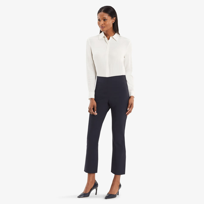 Hero image of a woman wearing the Oshima pant in dark navy and the Lagarde shirt in cream.