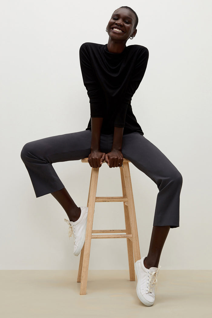 Side image of a woman standing wearing the Oshima pant in Monsoon | Grid | Exclude