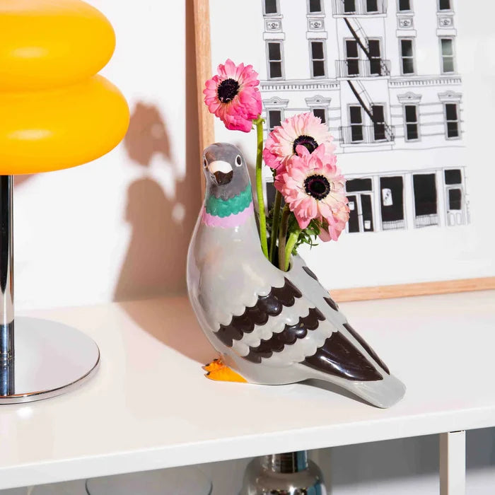 Ceramic pigeon-shaped vase in a living room setting.