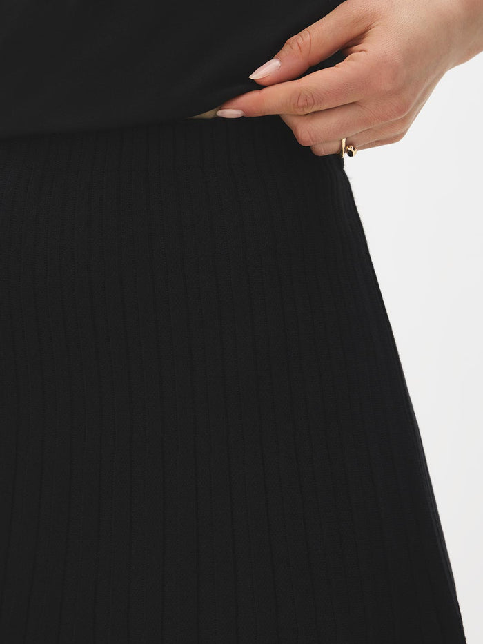 Black Pleated Sweater Knit Flippy Mini Skirt - Close-up Fabric Detail - Suzy Shier